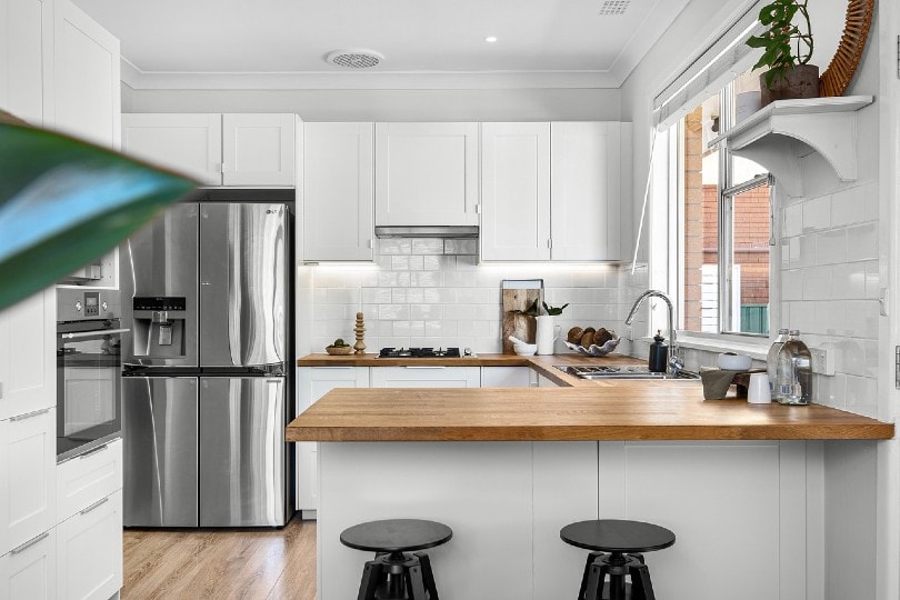 small kitchen with white tiles as backsplash