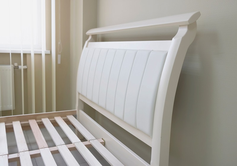 soft headboard of a wooden bed