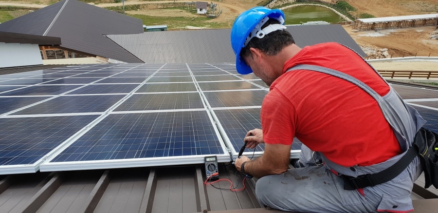 technician fixing solar panel