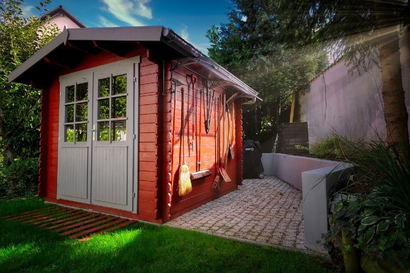 tools hanging on garden shed