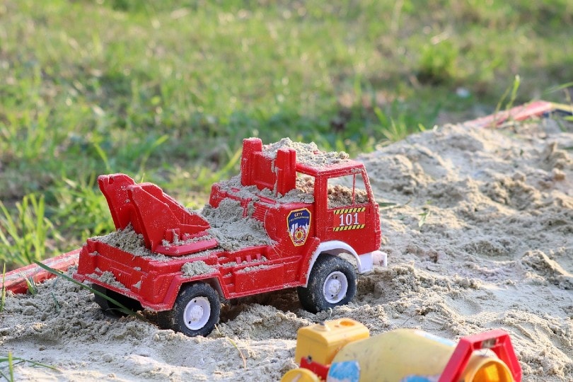 toys on a garden sandbox