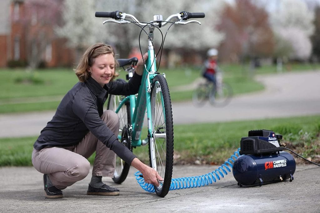 woman using Campbell Hausfeld FP209499AV Air Compressor