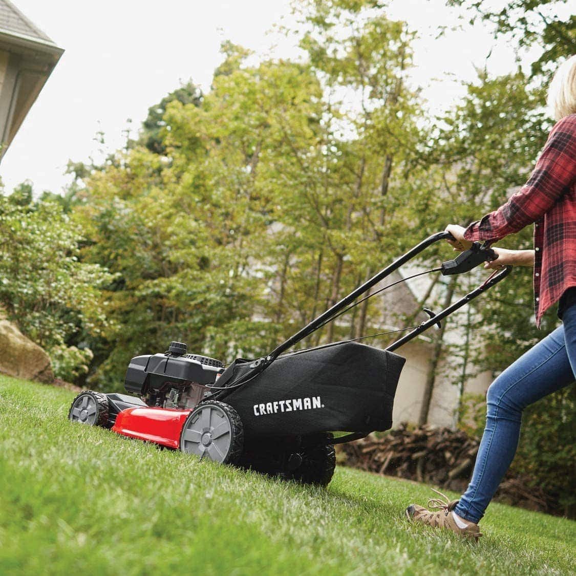 woman using Craftsman M215 Self-Propelled Gas Powered Lawn Mower