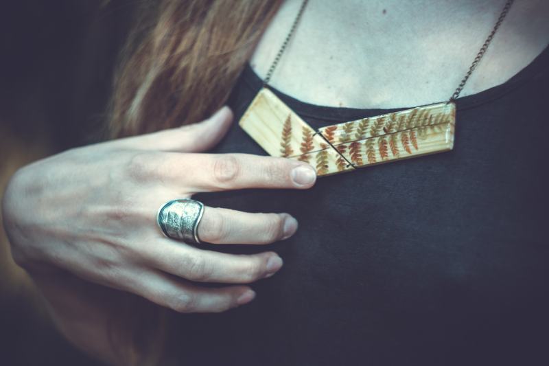 woman with metal ring and wooden pendant
