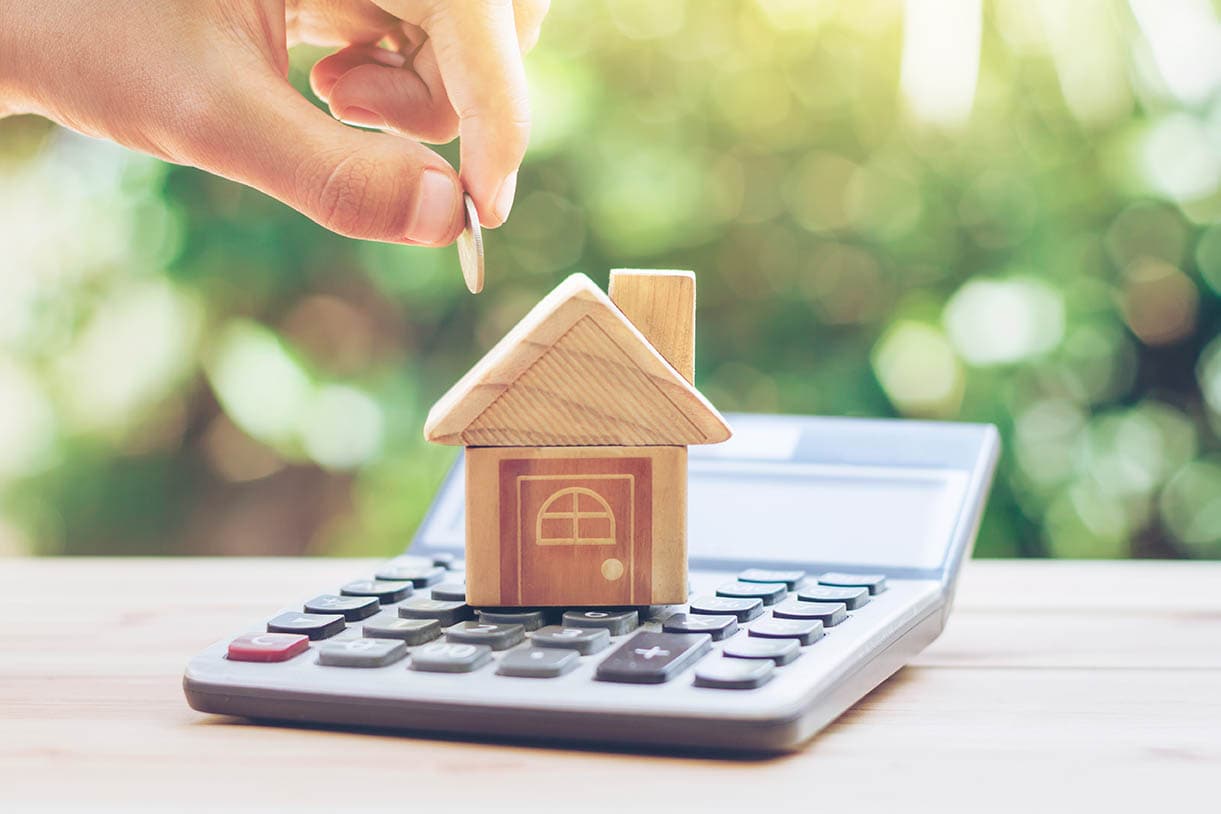 wooden house and calculator