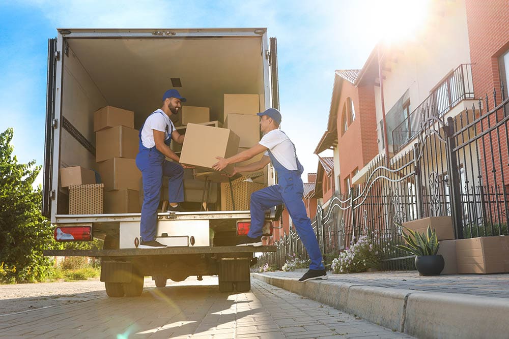 Workers unloading boxes from a moving truck